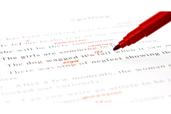 A red pen editing a document.