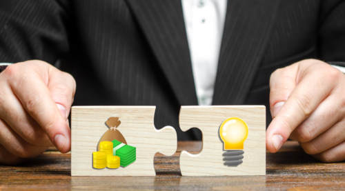 a man about to connect two puzzle pieces: capital and ideas.