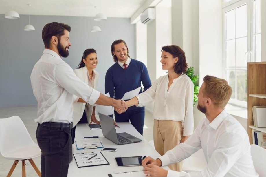 Two people shake hands after a successful negotiation.