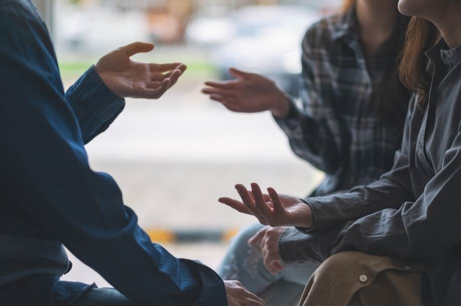 Three people confidently engaging in a difficult conversation.