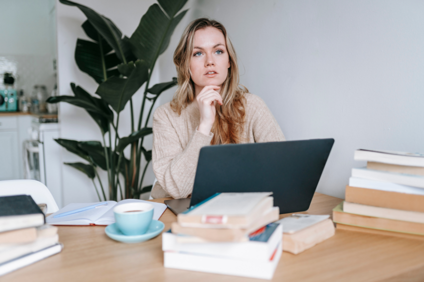 woman sitting at a desk contemplating grammar rules