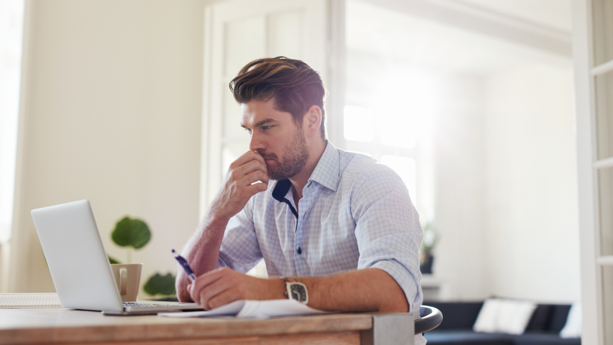 business man sitting at his desk looking at his computer
