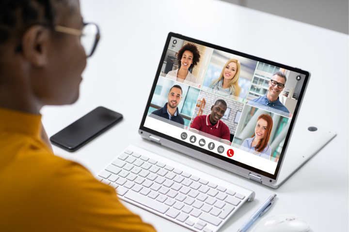 A person in a vitural meeting sitting at their computer.