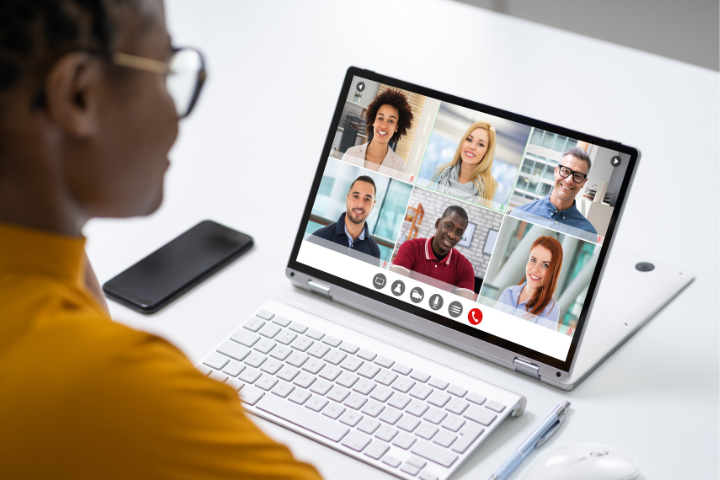 A person in a vitural meeting sitting at their computer. 