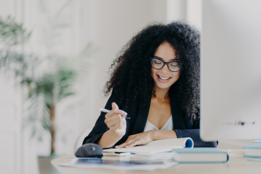 business woman writing in a journal