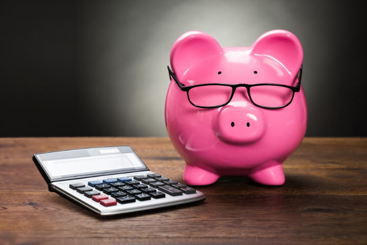 A calculator and a piggy bank.