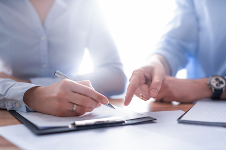 Two people editing a document.