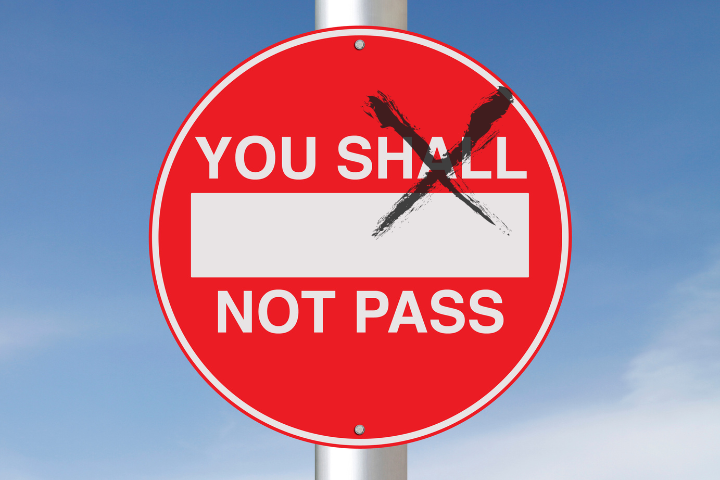 A road sign saying you shall not pass.  Shall is crossed out.