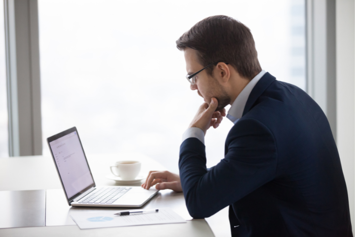 A person sitting at their laptop reading their email.