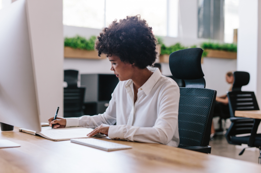 woman writing policies and procedures